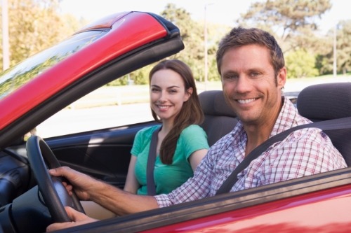 Couple with car insurance provide by their travel insurance by American Express Travel Insurance.